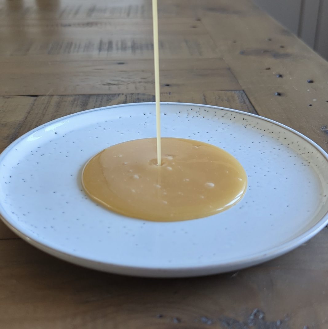 Salted caramel being poured onto a plate