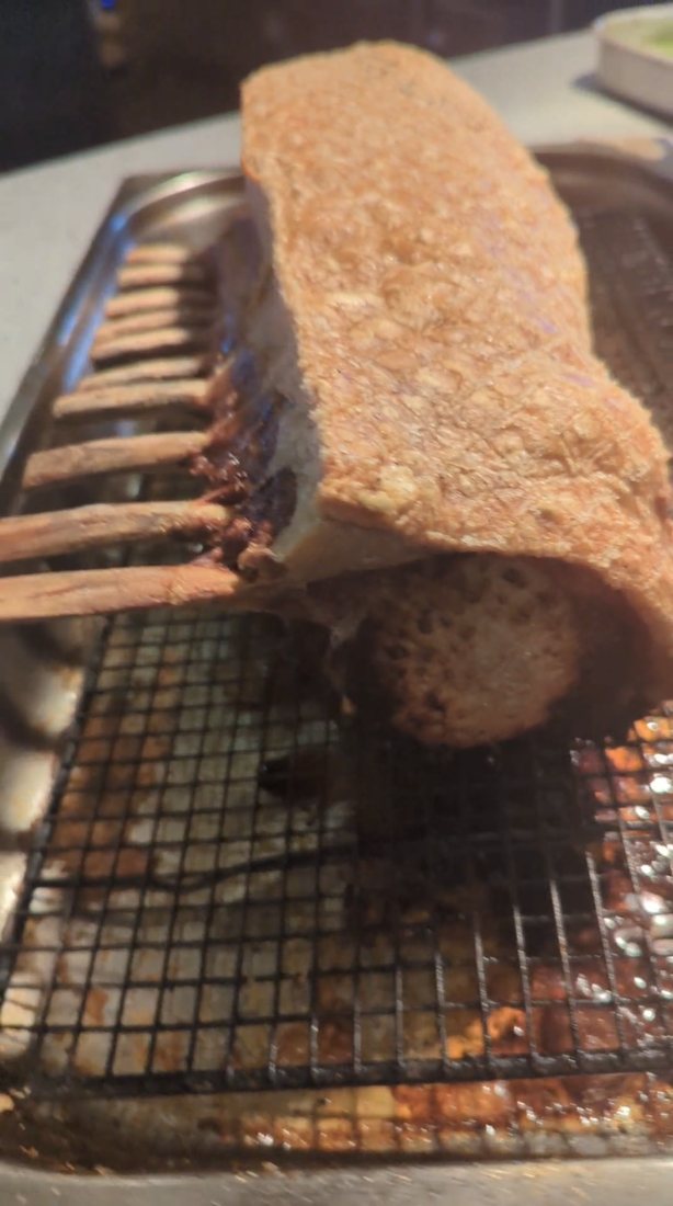 A whole pork rack roasted with the crackling on, bones frenched
